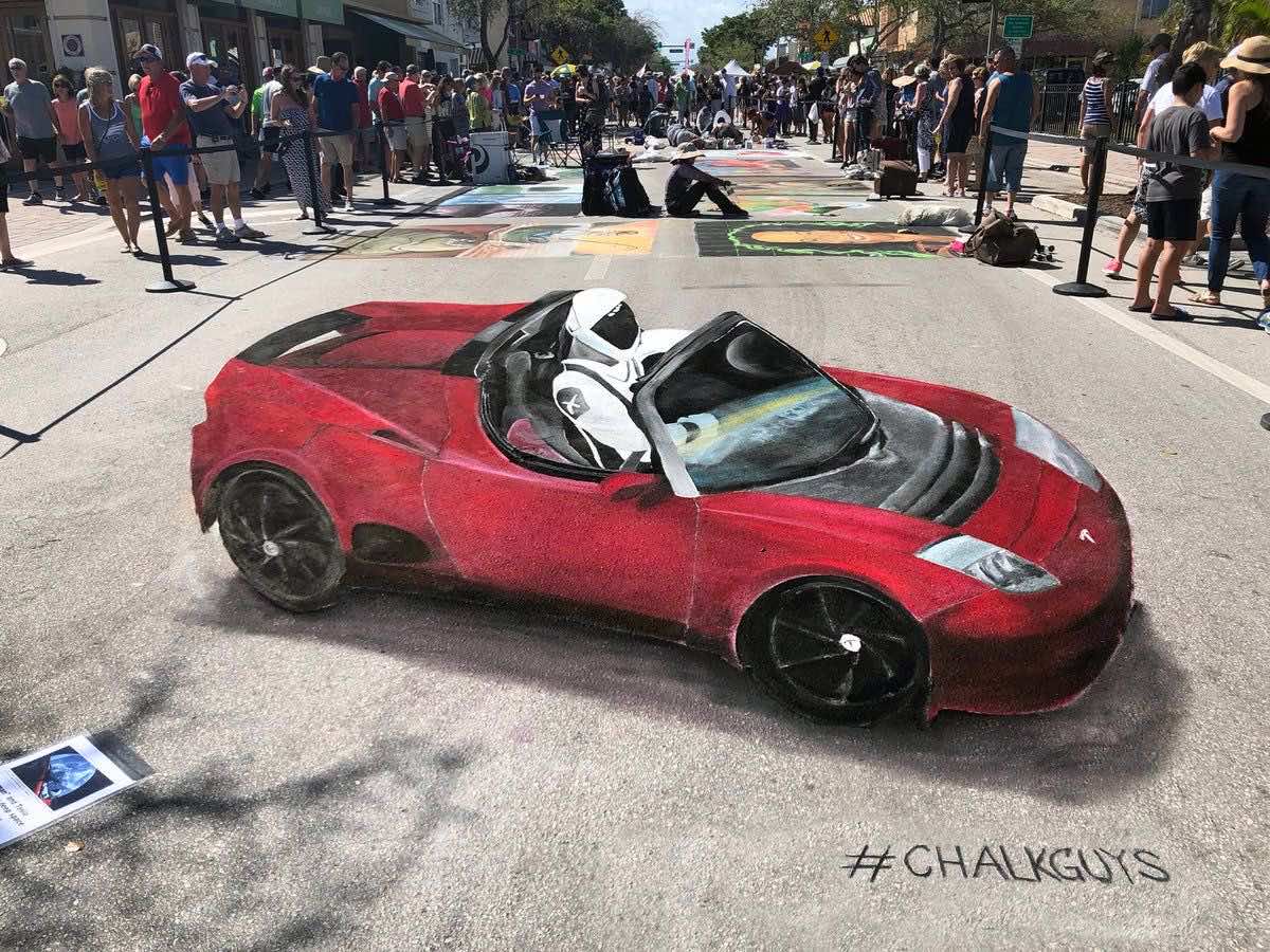 Σκίτσο του Starman ακινητοποιημένος μέσα σε ένα κόκκινο Tesla στη μέση του δρόμου
