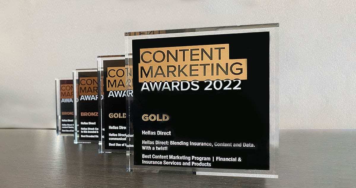 τέσσερα γυάλινα τετράγωνα στη σειρά, το καθένα γράφει content marketing awards 2022 και Hellas Direct